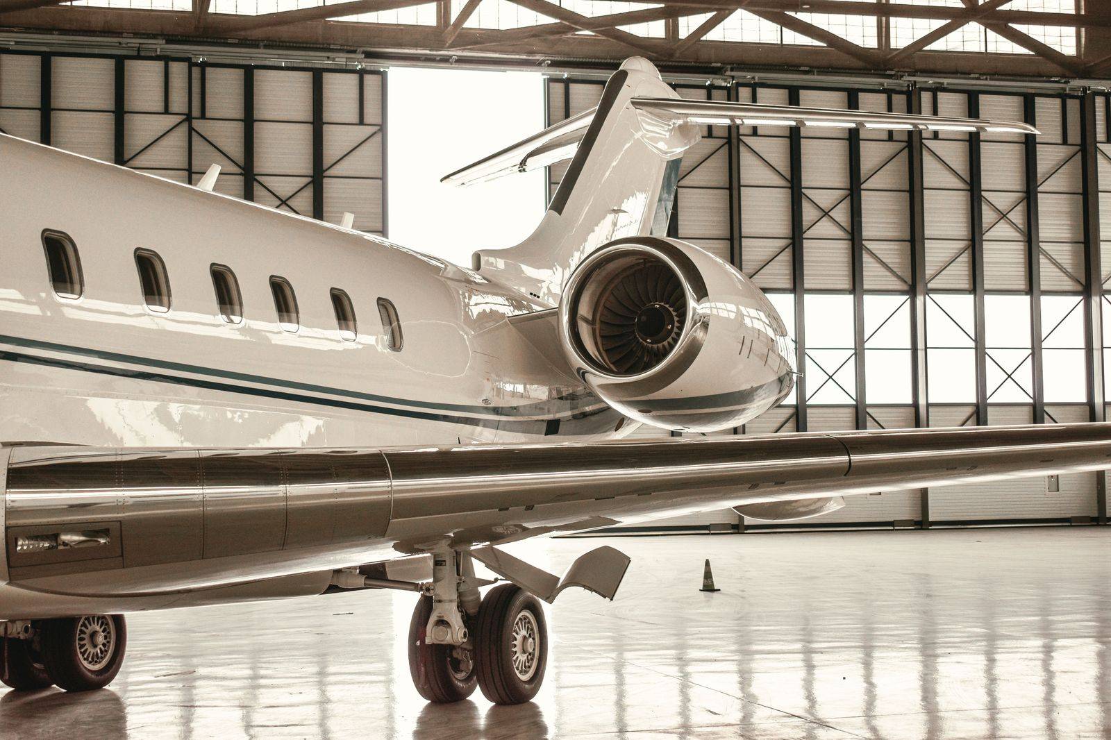 Ramp-side at the FBO: the car at the aircraft steps, the chauffeur moving the luggage