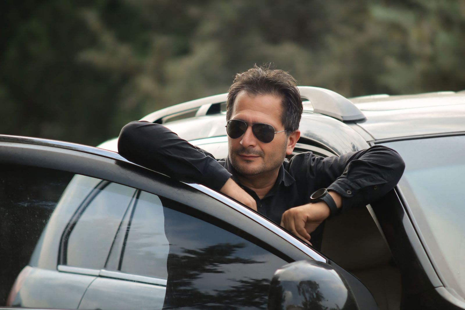 A security-trained chauffeur at the vehicle: door drill, position, eyes on the approach